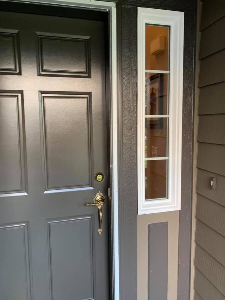 New front door installation with fresh paint and hardware