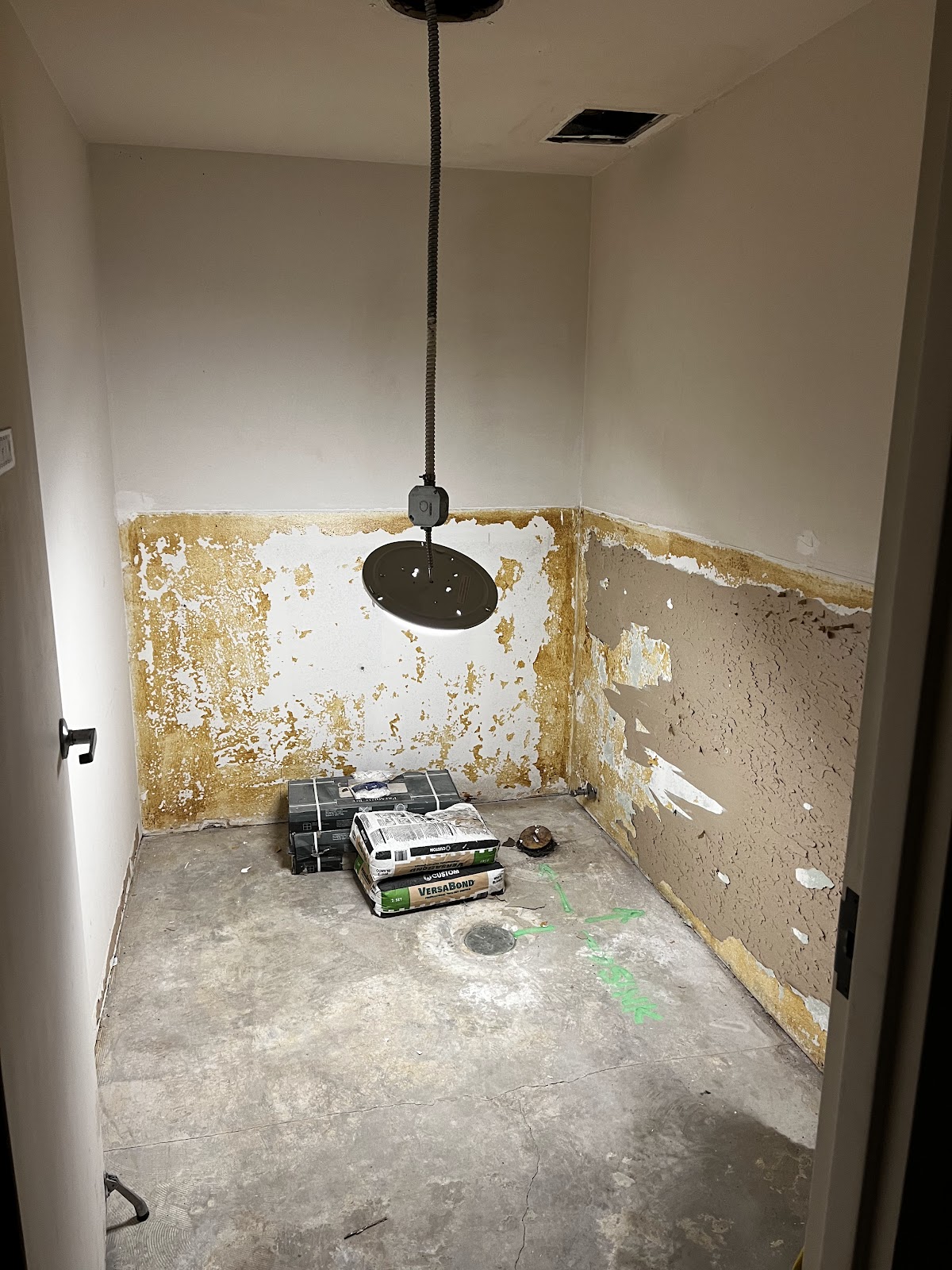 Bathroom stripped back to studs and wainscot line before drywall repair